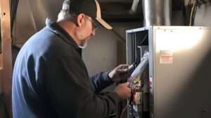 Male Technician Servicing Heating Unit Dimly Lit Room