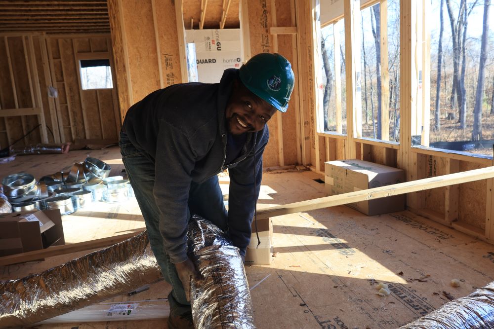 Tech installing ductwork 