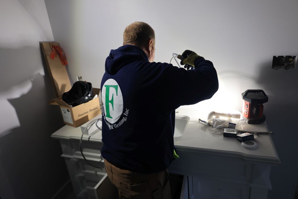 plumber checking pipes