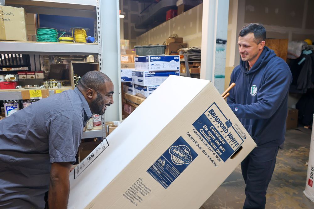 techs carrying water heater